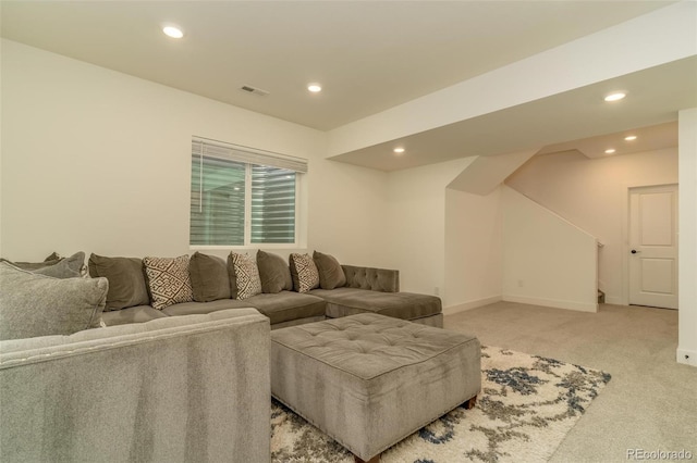 living room with baseboards, recessed lighting, visible vents, and light colored carpet