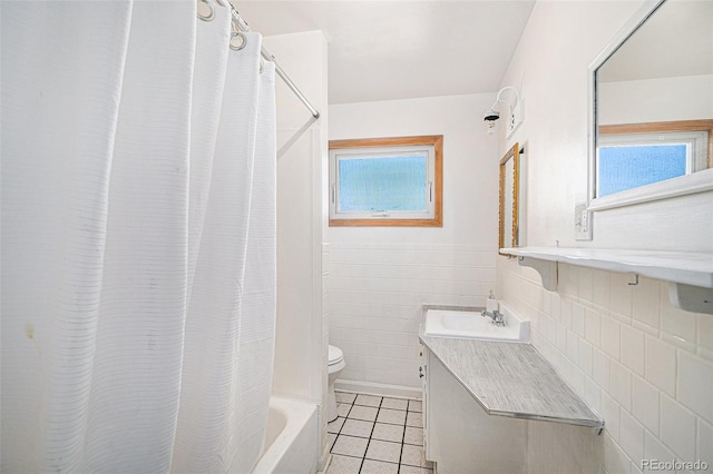 7887 Quivas Way, Denver, CO 80221 - full bath featuring tile patterned floors, shower / bath combo with shower curtain, tile walls, and vanity
