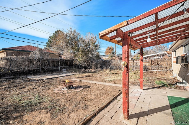 7887 Quivas Way, Denver, CO 80221 - fenced backyard featuring an outdoor fire pit and a patio