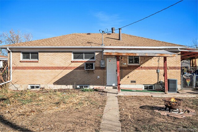 7887 Quivas Way, Denver, CO 80221 - back of house with brick siding, an outdoor fire pit, and a shingled roof
