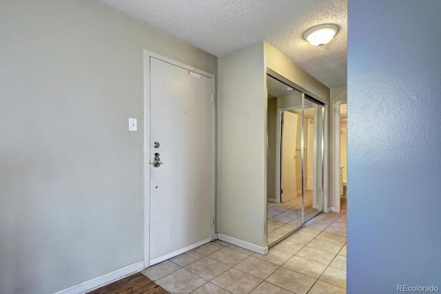 tiled entrance foyer with a textured ceiling