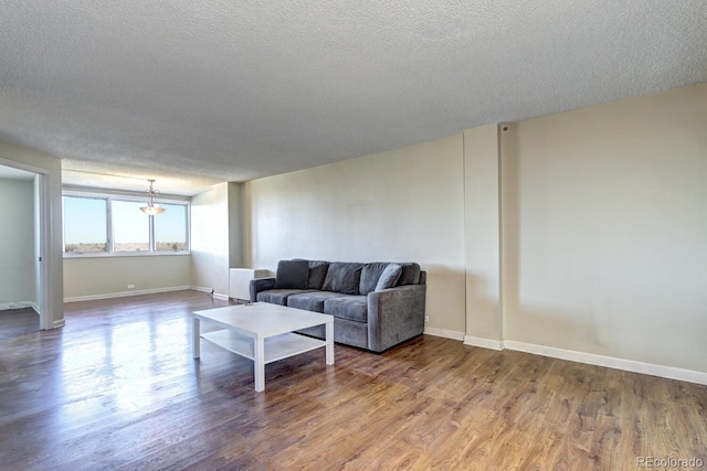 living room with hardwood / wood-style flooring and a textured ceiling