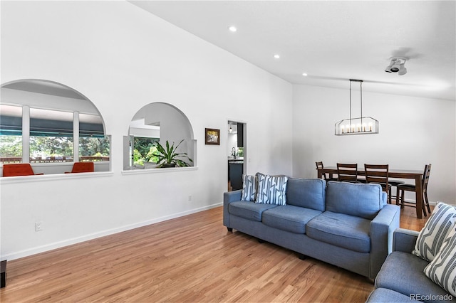 3253 S King Way, Denver, CO 80236 - living area featuring light wood finished floors, a chandelier, recessed lighting, baseboards, and high vaulted ceiling