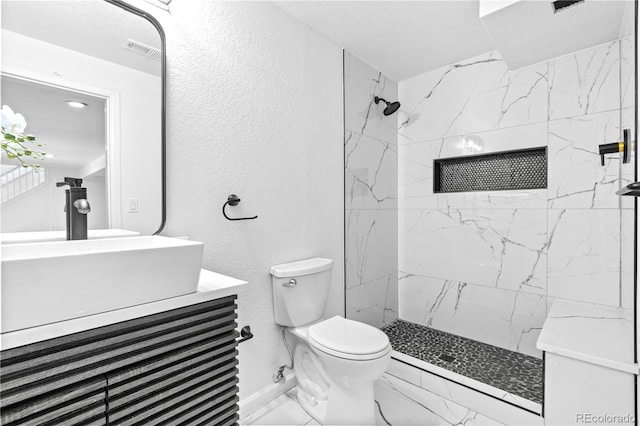 3253 S King Way, Denver, CO 80236 - full bath featuring marble finish floors, toilet, vanity, a marble finish shower, and a textured wall