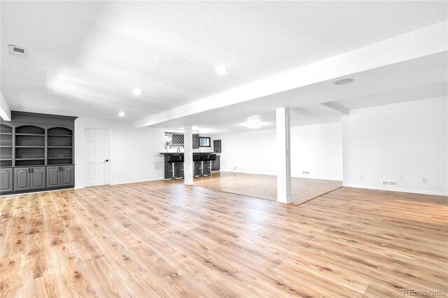 3253 S King Way, Denver, CO 80236 - unfurnished living room featuring bar, light wood-type flooring, recessed lighting, and baseboards