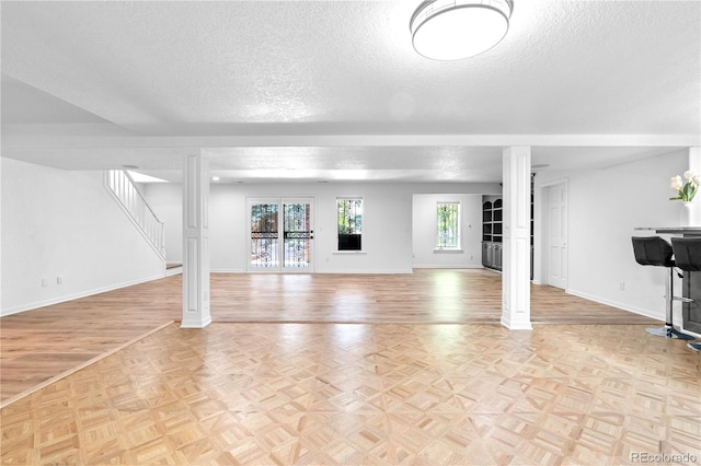 3253 S King Way, Denver, CO 80236 - basement with a textured ceiling, baseboards, and parquet flooring