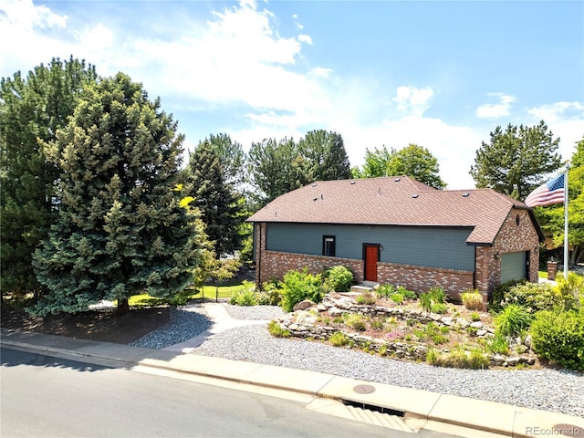 3253 S King Way, Denver, CO 80236 - view of front of house featuring brick siding and a garage