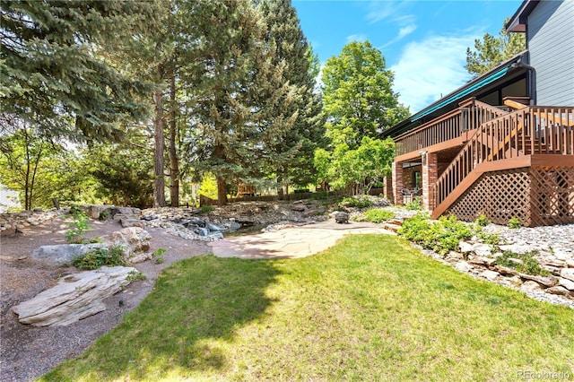 3253 S King Way, Denver, CO 80236 - view of grassy yard featuring a wooden deck, stairs, and a patio