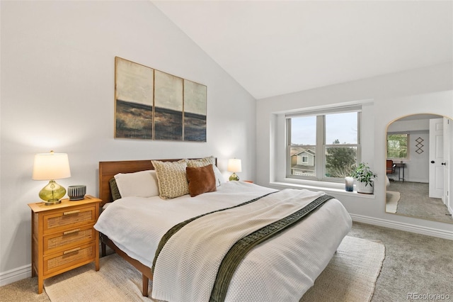 carpeted bedroom featuring lofted ceiling