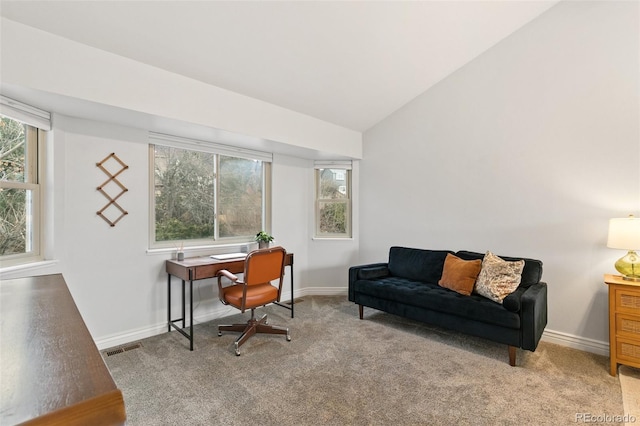 home office with light carpet and lofted ceiling