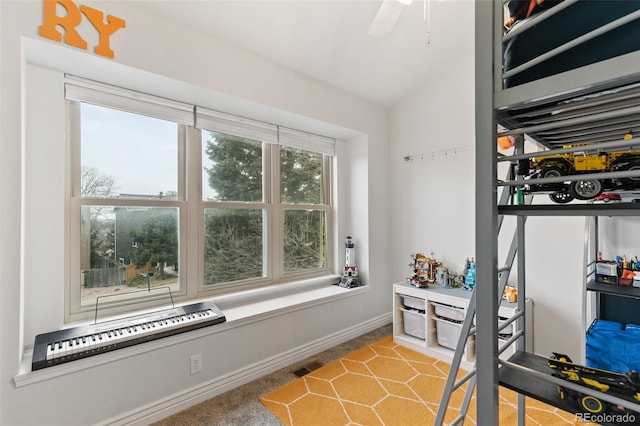 carpeted bedroom with multiple windows, ceiling fan, and lofted ceiling