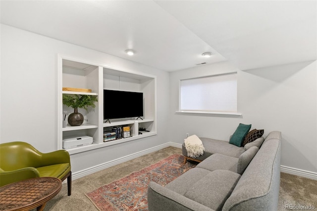 living room featuring built in shelves and carpet