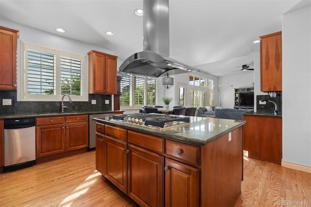 7071 Turweston Ln, Castle Pines, CO 80108 - kitchen with a sink, island exhaust hood, appliances with stainless steel finishes, a center island, and light wood finished floors