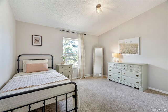 16580 Sagecreek Rd, Peyton, CO 80831 - carpeted bedroom with a textured ceiling, baseboards, and vaulted ceiling