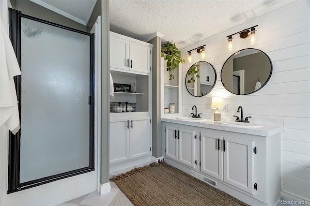 16580 Sagecreek Rd, Peyton, CO 80831 - bathroom with double vanity, a stall shower, and a textured ceiling