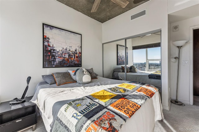 carpeted bedroom with ceiling fan and a closet