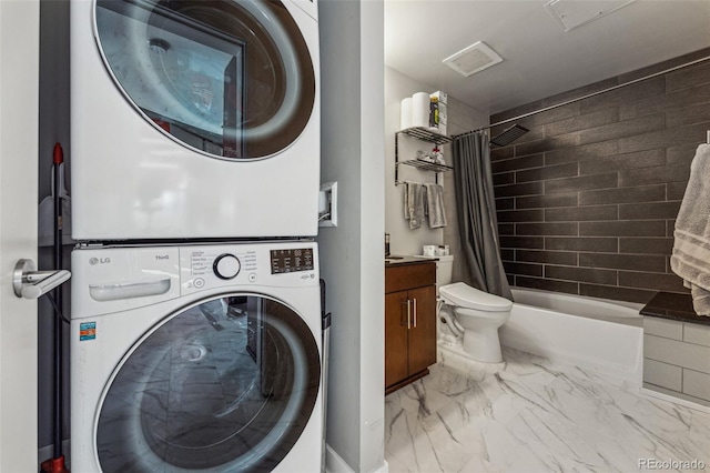 laundry room featuring stacked washer / dryer