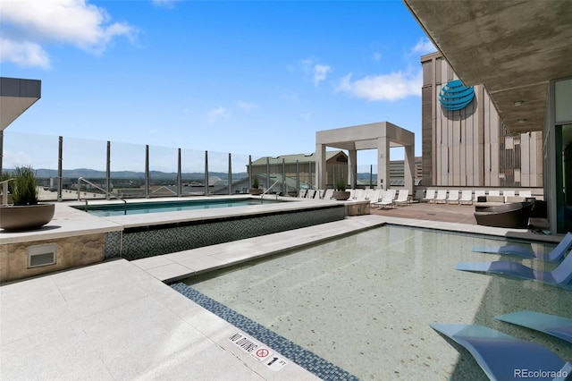 view of pool featuring a mountain view and a patio