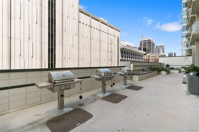 view of patio / terrace with exterior kitchen and a grill