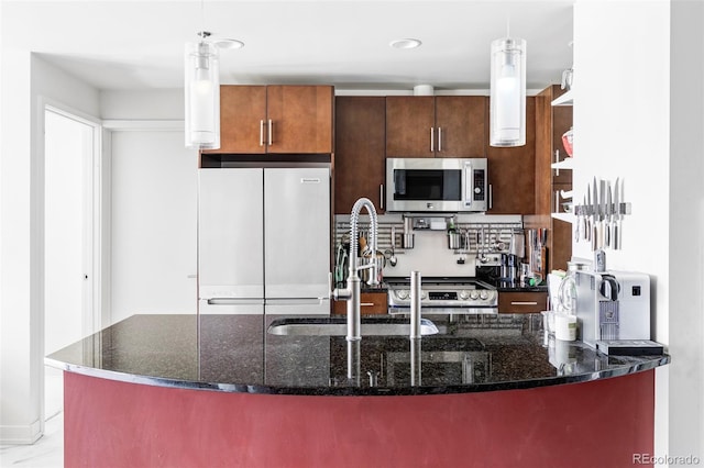 891 14th St Unit 2816, Denver, CO 80202 - kitchen featuring appliances with stainless steel finishes, a sink, pendant lighting, and dark stone counters