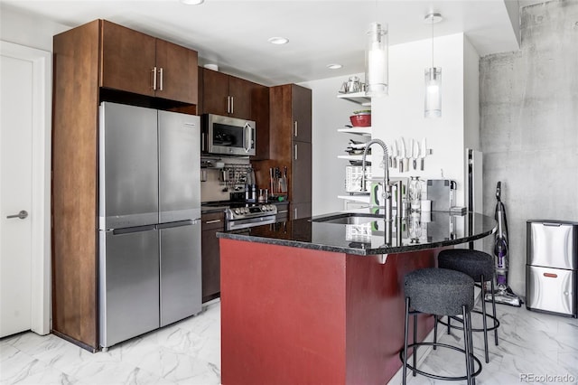 891 14th St Unit 2816, Denver, CO 80202 - kitchen featuring appliances with stainless steel finishes, a sink, light marble finish flooring, a breakfast bar area, and dark stone counters