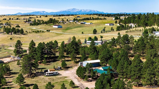 birds eye view of property featuring a mountain view and a rural view