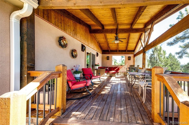 deck with outdoor dining space and ceiling fan