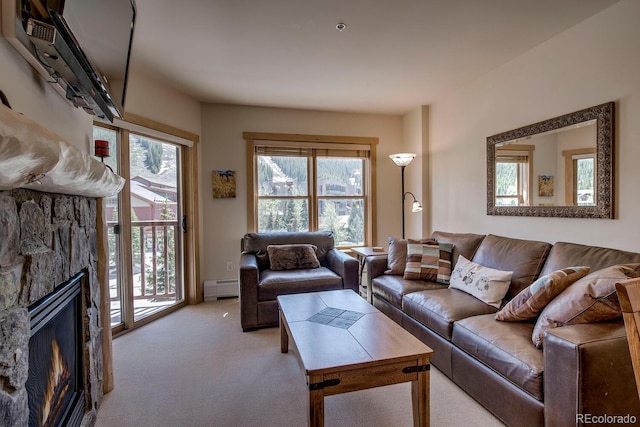 105 Wheeler Cir Unit 334, Frisco, CO 80443 - living room with a baseboard radiator, carpet, healthy amount of natural light, and a stone fireplace