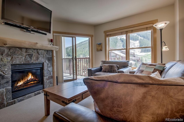 105 Wheeler Cir Unit 334, Frisco, CO 80443 - living area featuring a fireplace, plenty of natural light, and carpet floors