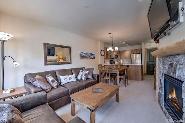 105 Wheeler Cir Unit 334, Frisco, CO 80443 - living area with light carpet, a chandelier, a fireplace, and rail lighting