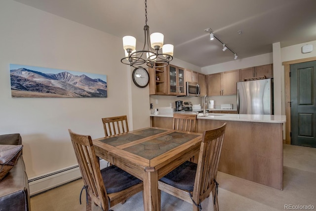 105 Wheeler Cir Unit 334, Frisco, CO 80443 - dining area with a chandelier, light carpet, baseboard heating, and track lighting