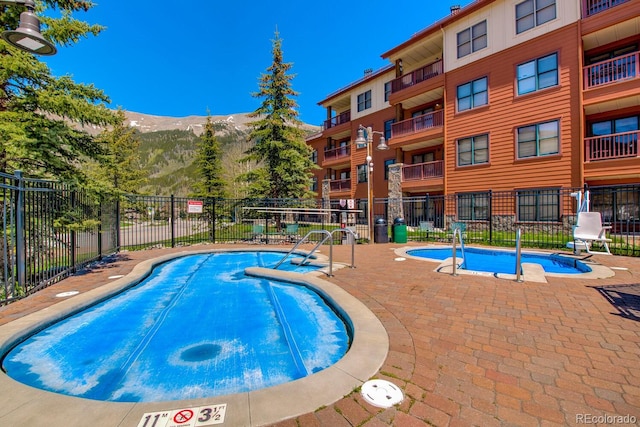 105 Wheeler Cir Unit 334, Frisco, CO 80443 - community pool featuring a mountain view and a patio