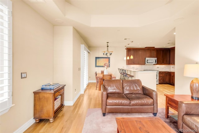 living room featuring light hardwood / wood-style flooring and a chandelier