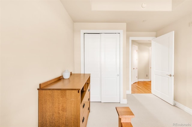 bedroom featuring light carpet and a closet