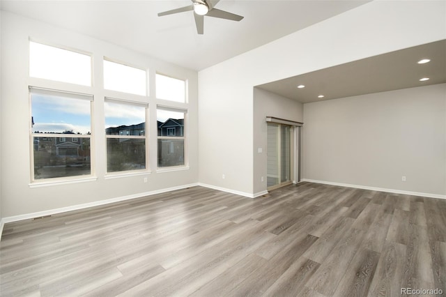 unfurnished room with ceiling fan and wood-type flooring