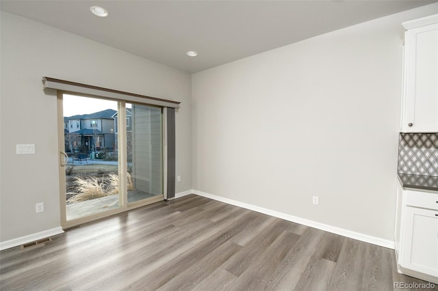 unfurnished dining area featuring hardwood / wood-style floors