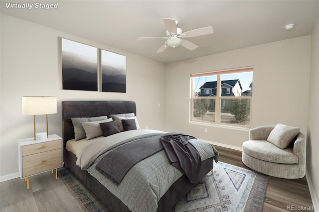 bedroom with ceiling fan and dark hardwood / wood-style floors