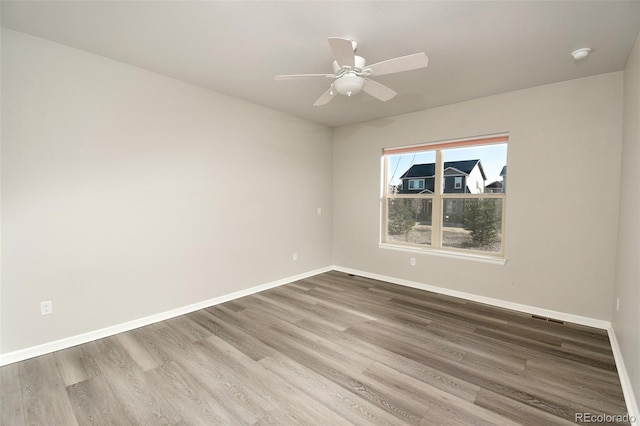 unfurnished room featuring hardwood / wood-style flooring and ceiling fan