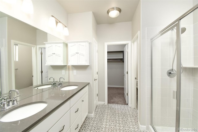 bathroom featuring tile patterned flooring, vanity, and a shower with shower door