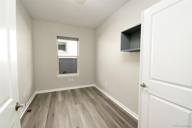 spare room with hardwood / wood-style flooring