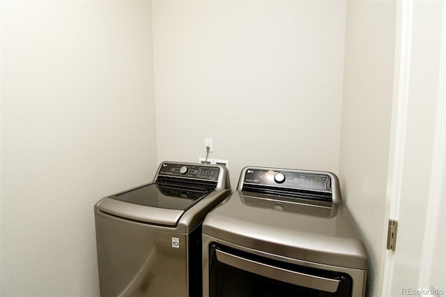 clothes washing area with independent washer and dryer