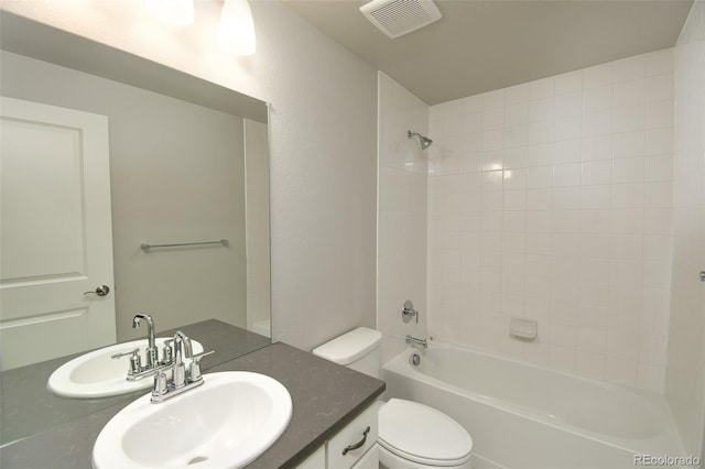 full bathroom featuring vanity, toilet, and tiled shower / bath