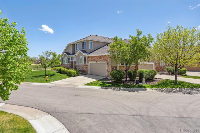 view of front facade featuring concrete driveway, a front lawn, an attached garage, and brick siding