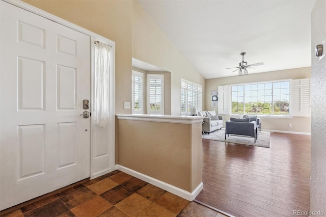 entrance foyer featuring plenty of natural light, ceiling fan, baseboards, and lofted ceiling