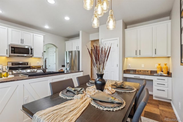 dining area featuring recessed lighting and arched walkways