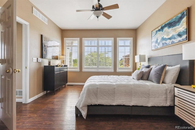 bedroom with hardwood / wood-style flooring, multiple windows, baseboards, and a ceiling fan