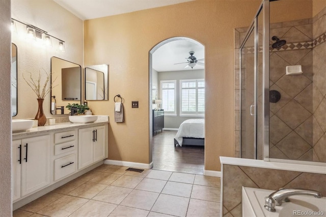 full bathroom featuring ceiling fan, a stall shower, tile patterned floors, and double vanity
