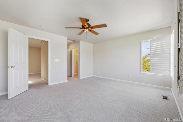unfurnished bedroom featuring carpet, baseboards, and a ceiling fan