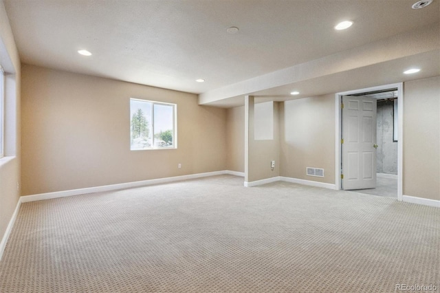 basement with light carpet, baseboards, and recessed lighting