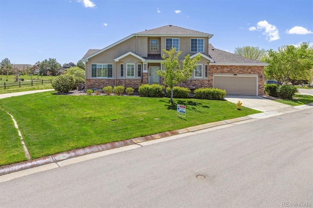 view of front of property featuring an attached garage, driveway, stone siding, stucco siding, and roof with shingles